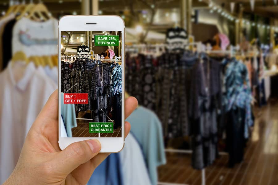 Person holding iPhone with augmented reality app in a clothing store